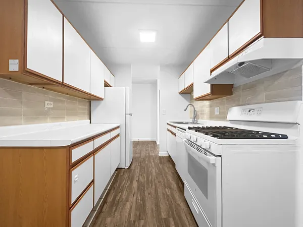 a kitchen with stainless steel appliances granite countertop a stove and a refrigerator