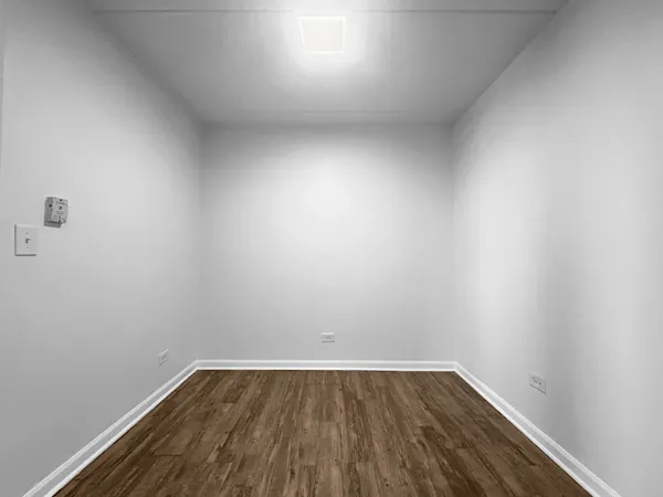 a view of an empty room and wooden floor