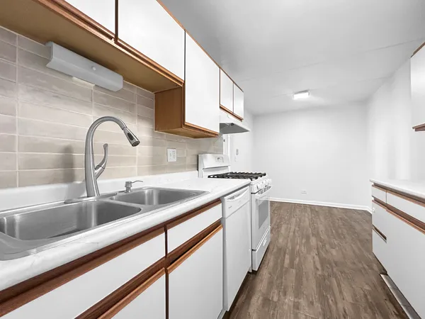 a kitchen with a sink and cabinets