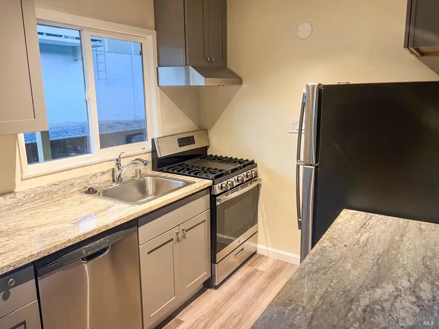 a kitchen with a sink and a stove