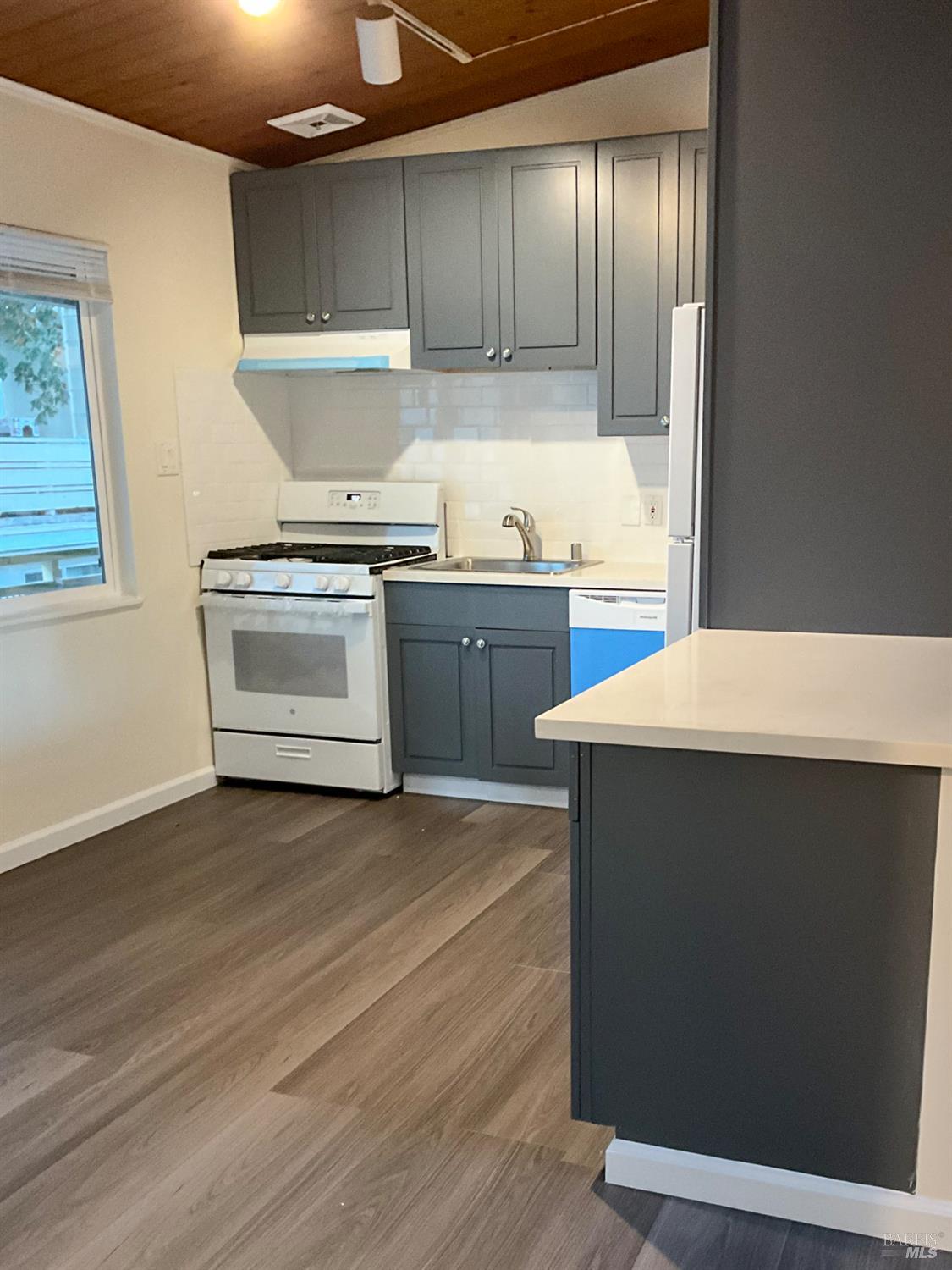 131 Kent Avenue Kentfield, CA 94904 - Photo 17 of 21 a kitchen with a sink cabinets and wooden floor