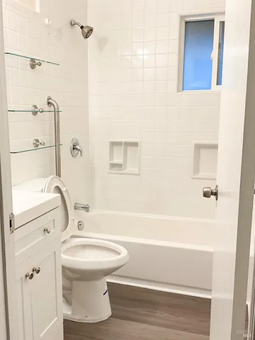a bathroom with a toilet and a shower