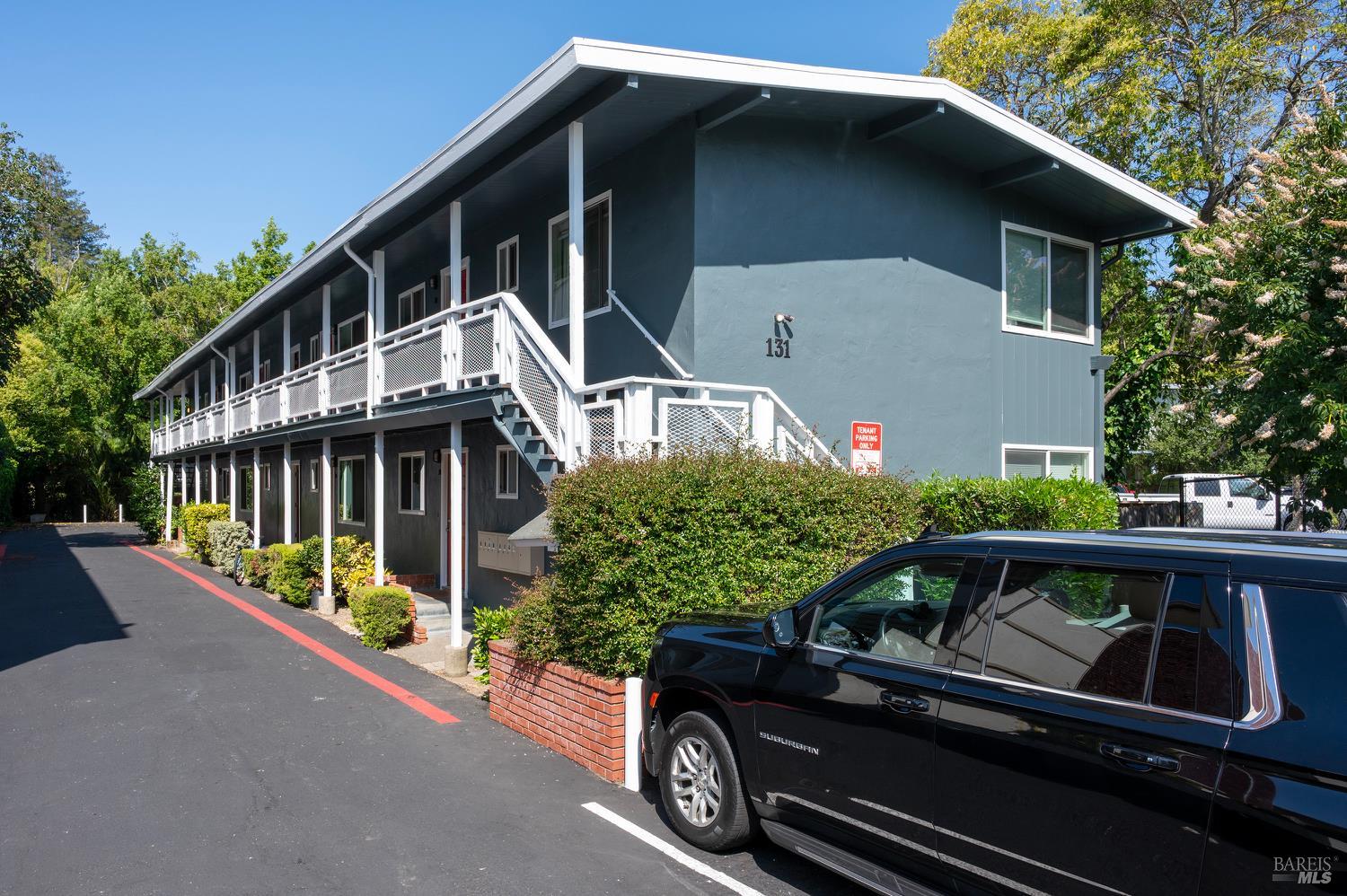 131 Kent Avenue Kentfield, CA 94904 - Photo 2 of 21 a car parked in front of a house with wooden fence