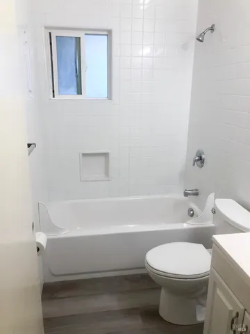 a bathroom with a toilet and a bath tub