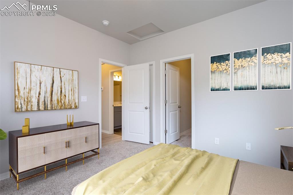 4447 Samaritan Loop Colorado Springs, CO 80916 - Photo 14 of 17 a spacious bedroom with a bed and a desk