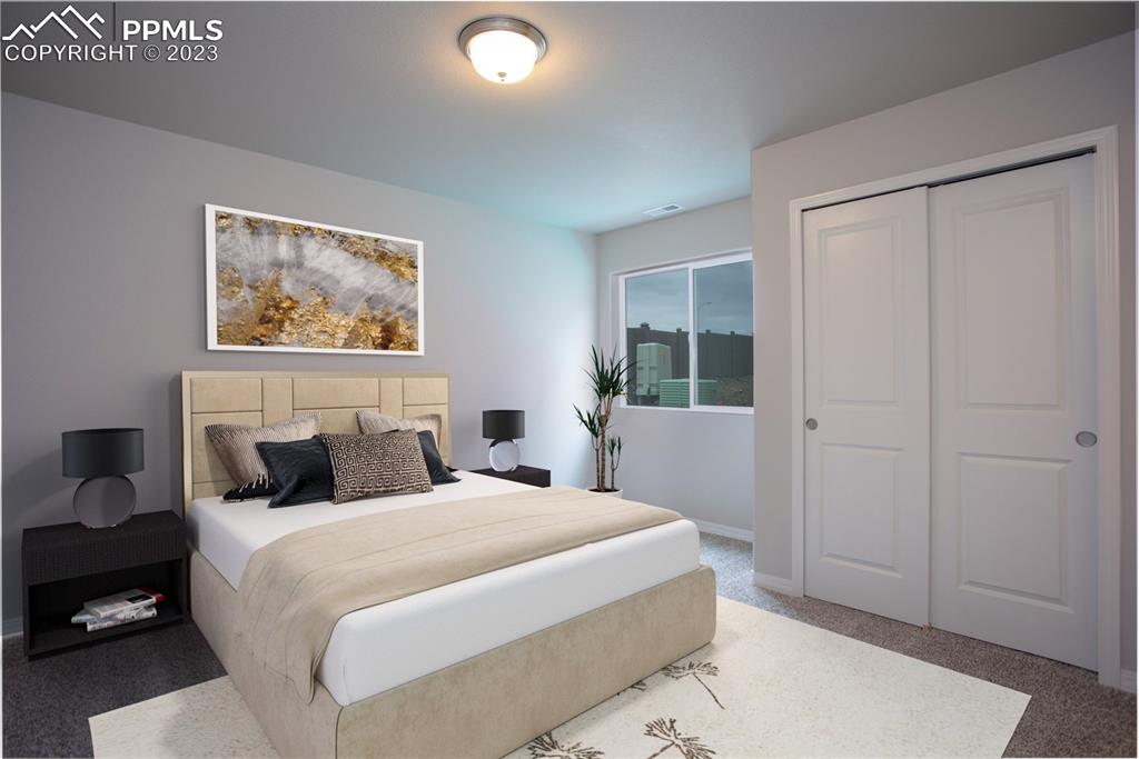 4447 Samaritan Loop Colorado Springs, CO 80916 - Photo 5 of 17 a bedroom with a large bed and a window