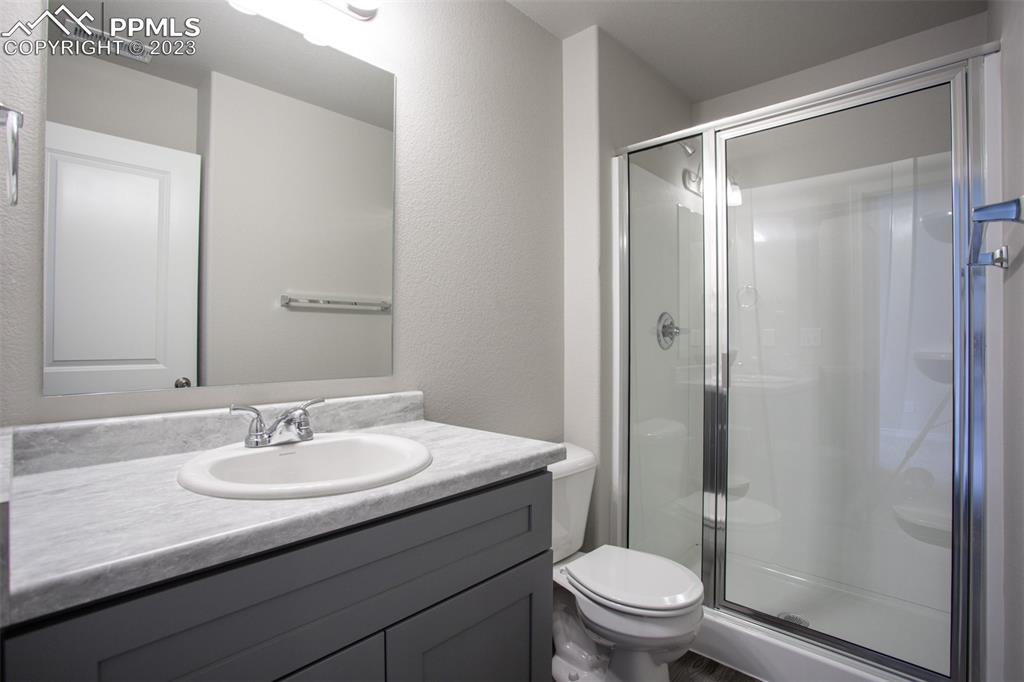 4447 Samaritan Loop Colorado Springs, CO 80916 - Photo 6 of 17 a bathroom with a sink toilet and shower