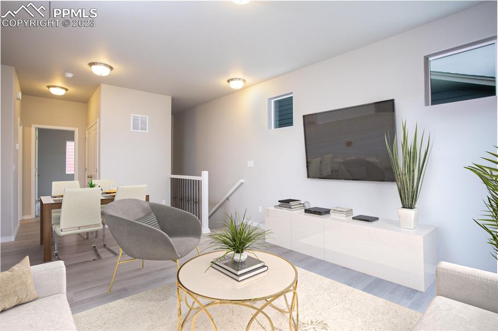 4447 Samaritan Loop Colorado Springs, CO 80916 - Photo 8 of 17 a living room with furniture and a flat screen tv