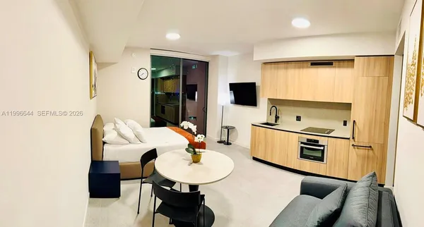 a kitchen with a sink appliances and cabinets