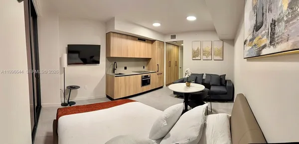 a bedroom with a bed and a flat screen tv