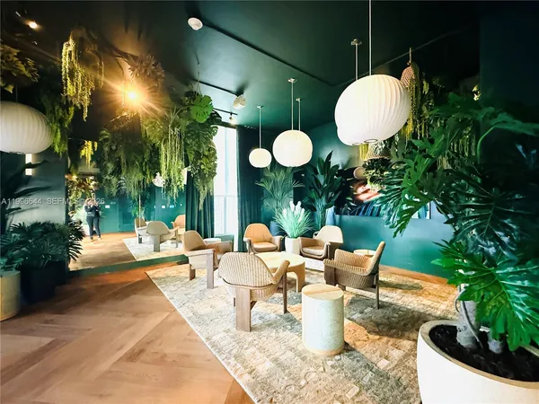 a view of a swimming pool with some potted plants