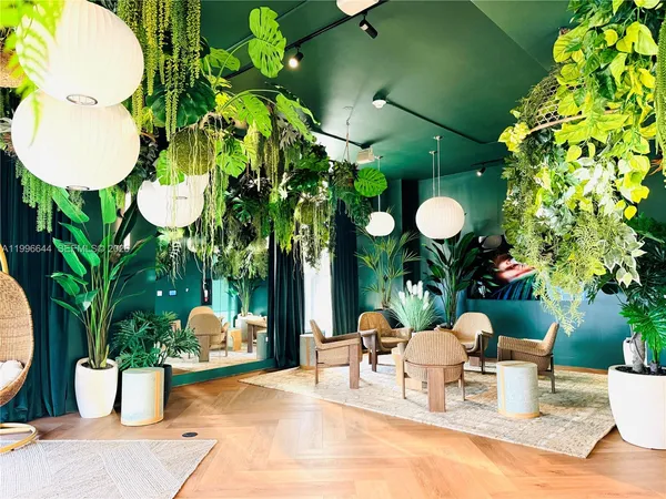 a couple of blue chairs sitting on a patio next to a yard