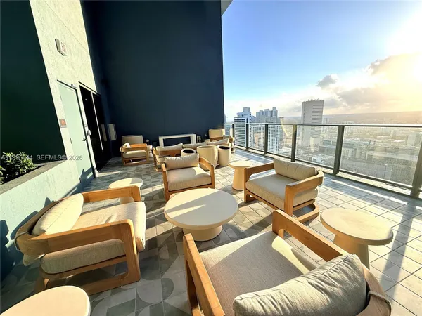 a dining hall with stainless steel appliances granite countertop a stove and a wooden floors