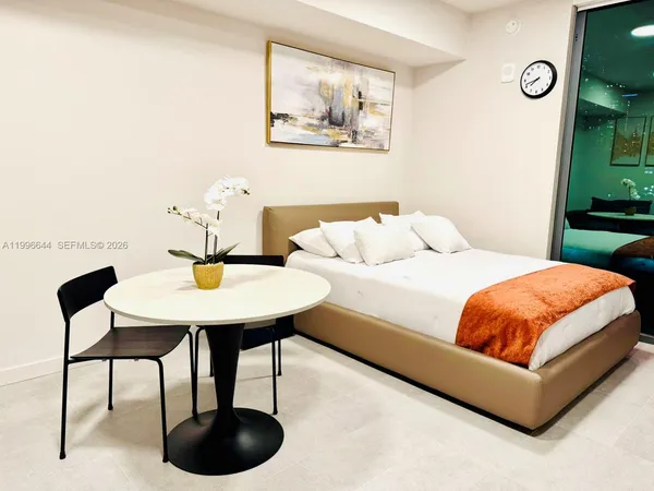 a bedroom with a bed and a table in it