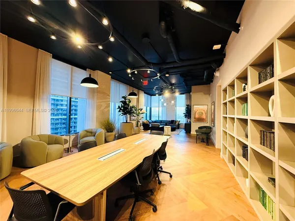 a view of a kitchen with furniture and floor to ceiling windows