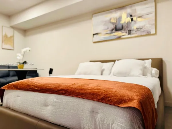 a bedroom with a bed and wall painting