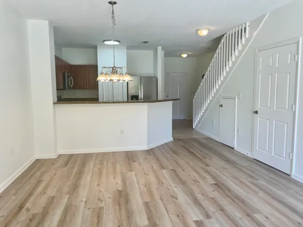a room with wooden floor and staircase