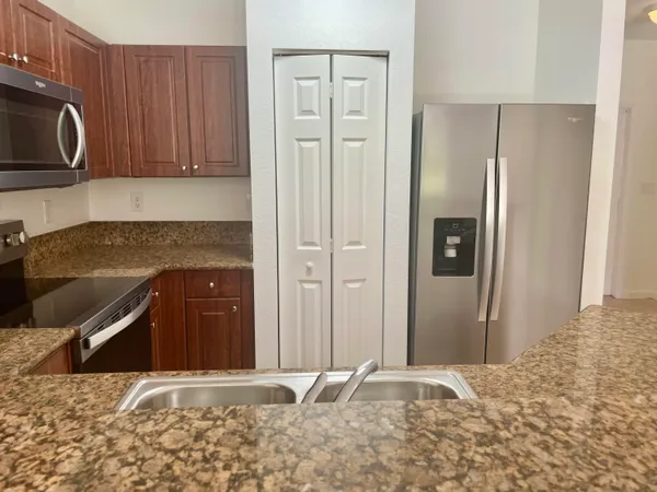 a view of a kitchen with granite countertop wooden cabinets and a granite counter top