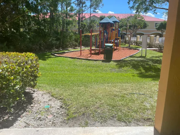 a view of a house with backyard and sitting area