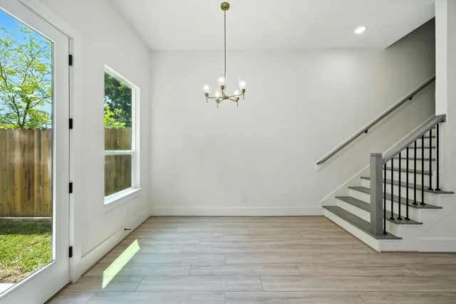 a view of a room with wooden floor and windows