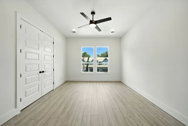wooden floor in an empty room with a window