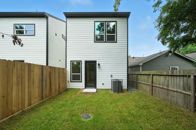 a view of a backyard with wooden fence