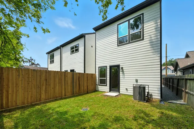 a view of backyard with barbeque grill and a tub