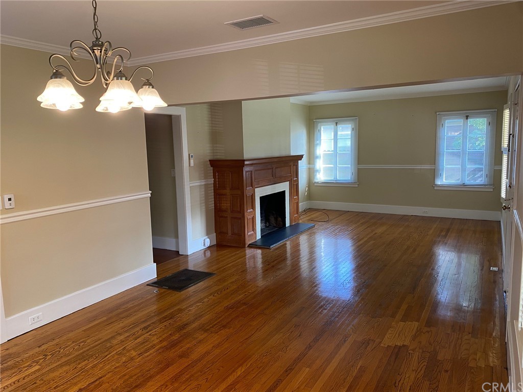 491 Eldora Road Pasadena, CA 91104 - Photo 2 of 14 a view of a livingroom with wooden floor a fireplace and windows