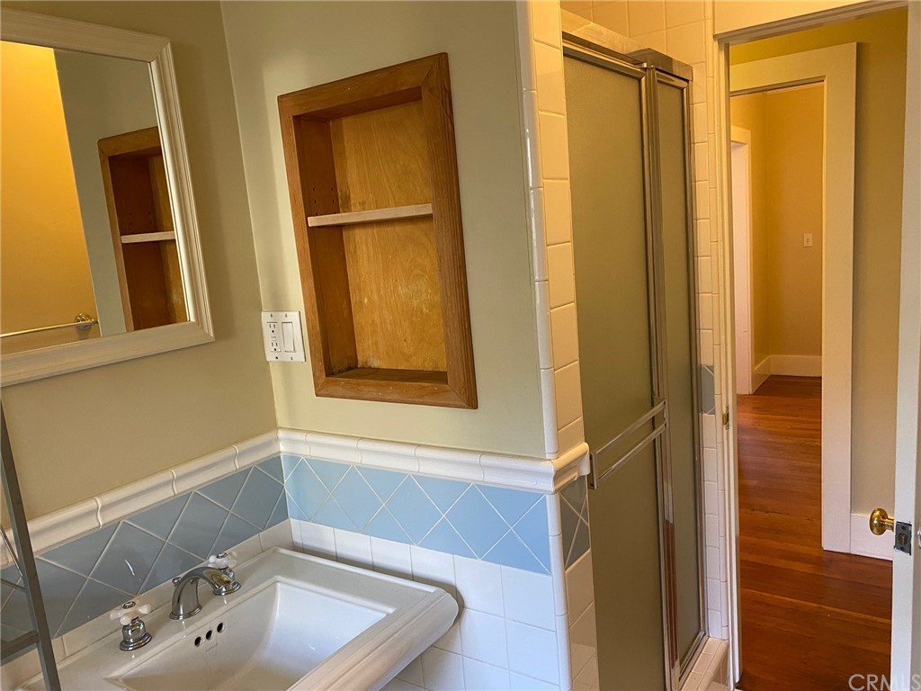 491 Eldora Road Pasadena, CA 91104 - Photo 10 of 14 a bathroom with a sink a window and a shower