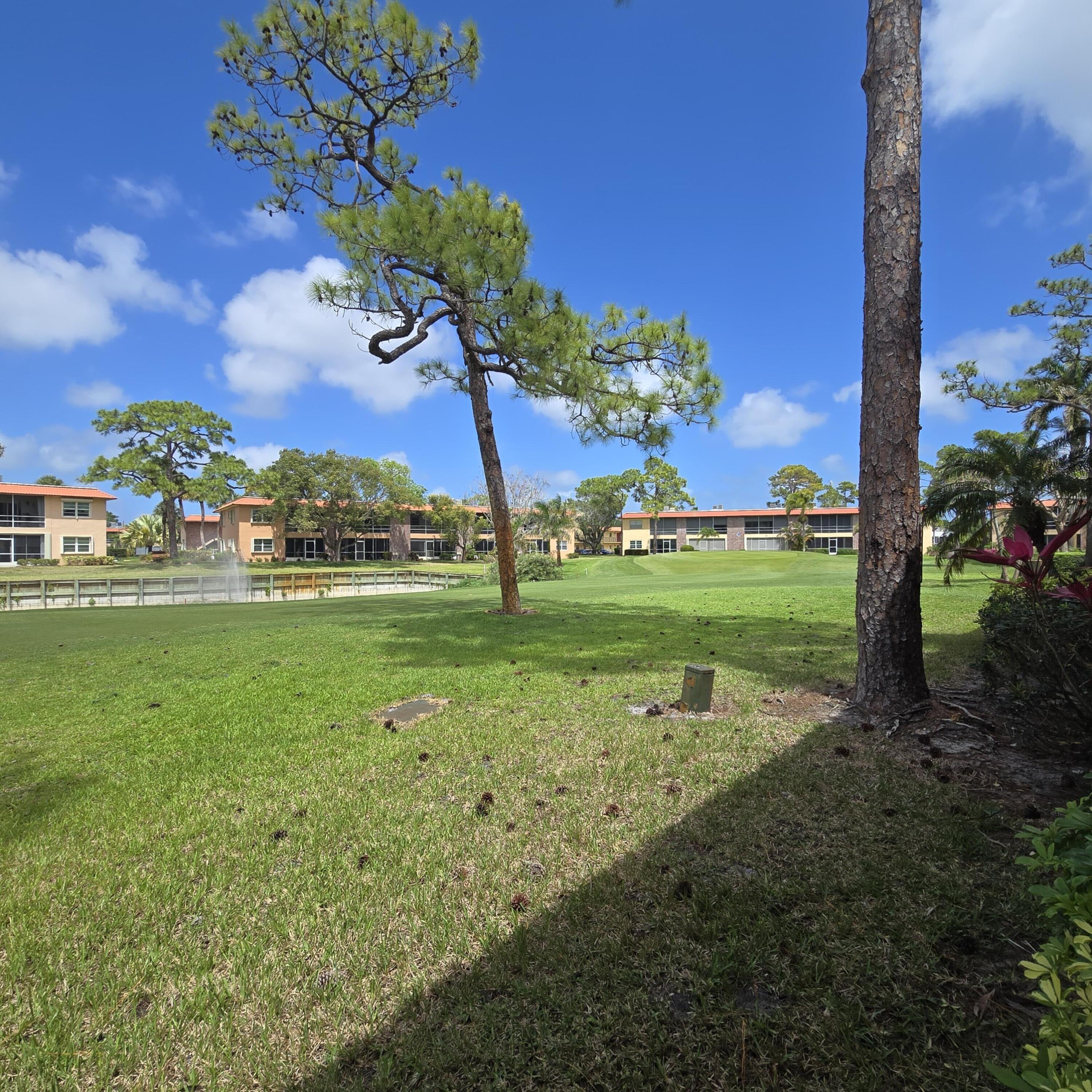 1967 Southwest Palm City Road, Unit 34C Stuart, FL 34994 - Photo 18 of 25 a view of a golf course with a big yard