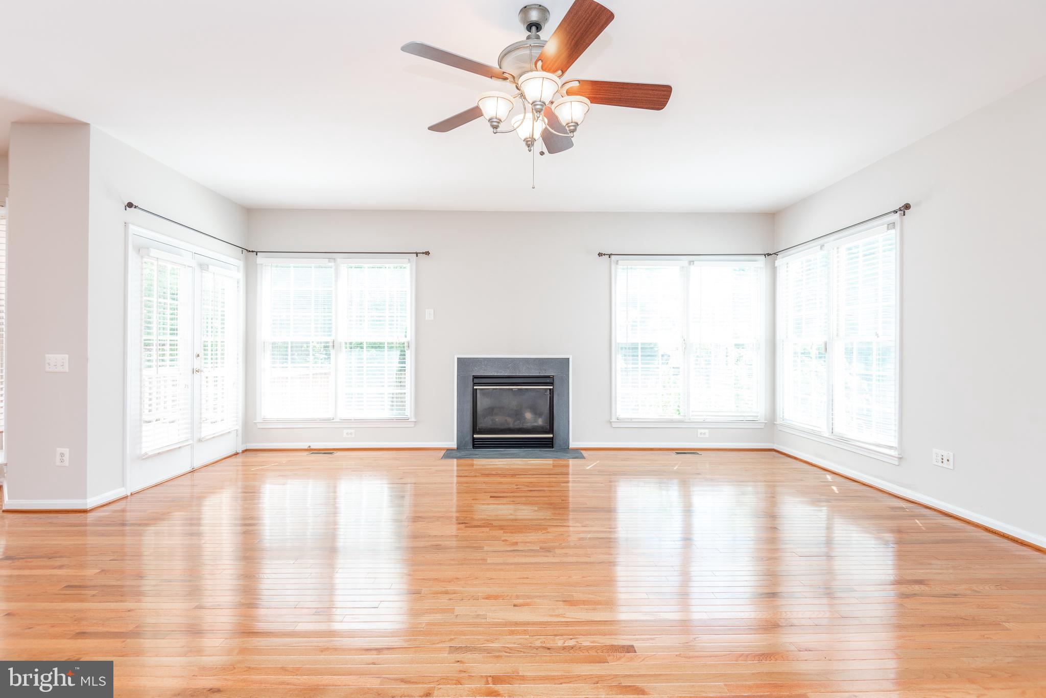 6033 Sumner Road Alexandria, VA 22310 - Photo 9 of 52 Living room with gas fireplace and ceiling fan