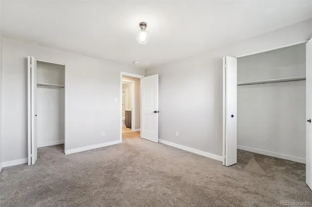 a view of an empty room with a closet