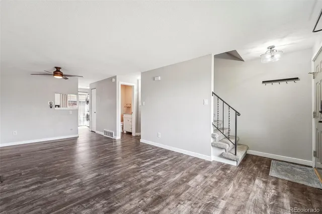 a view of empty room with wooden floor