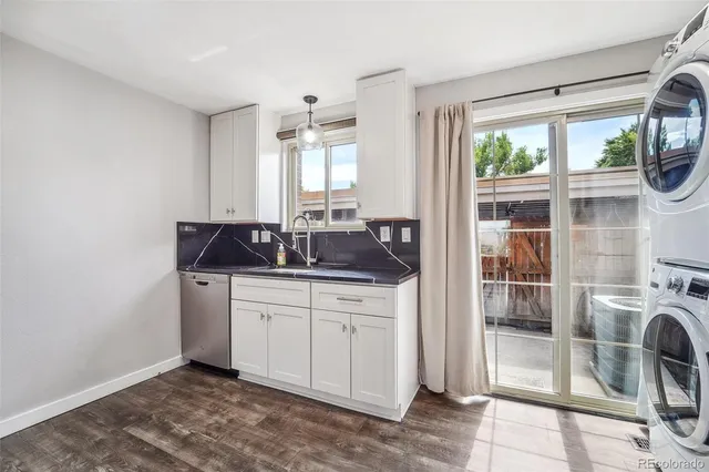 a kitchen with a sink and a refrigerator