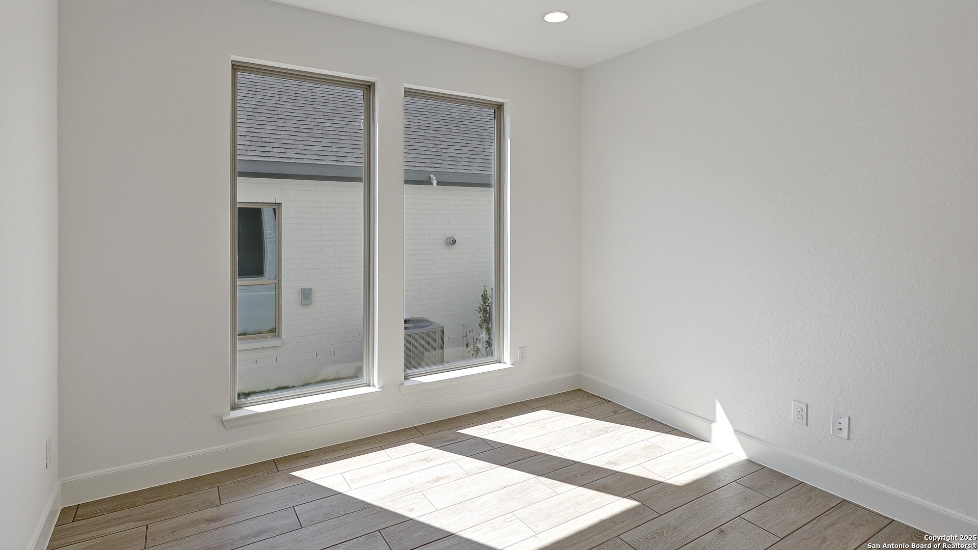 213 Hidalgo Boerne, TX 78006 - Photo 13 of 35 a view of an empty room with wooden floor and a window