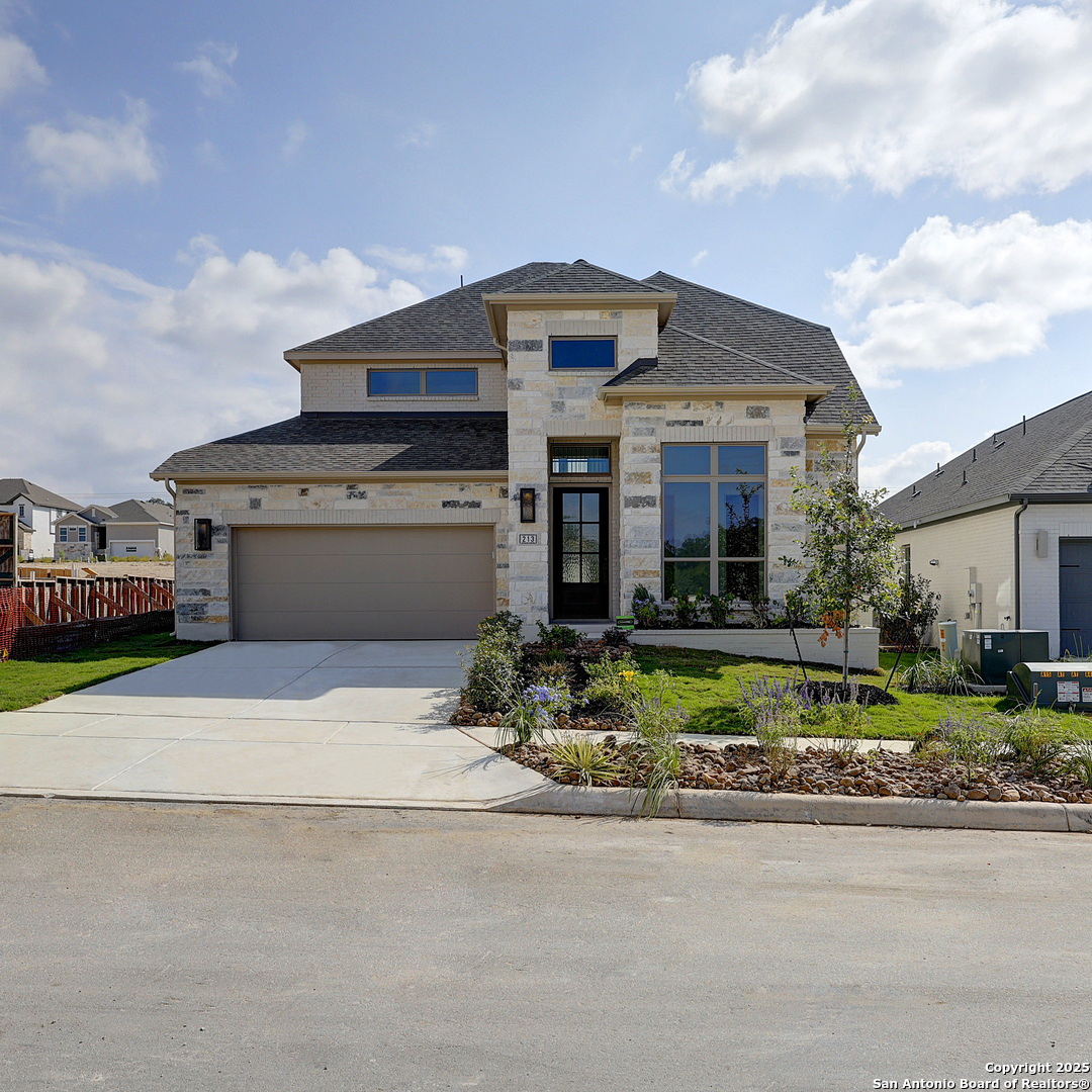 213 Hidalgo Boerne, TX 78006 - Photo 28 of 35 a front view of a house with a yard and garage