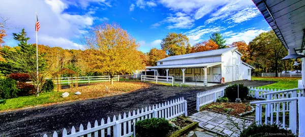 a view of a house with swimming pool and sitting area