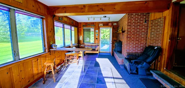 a living room with furniture and a floor to ceiling window