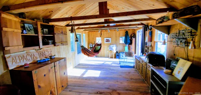a view of living room with furniture and wooden floor