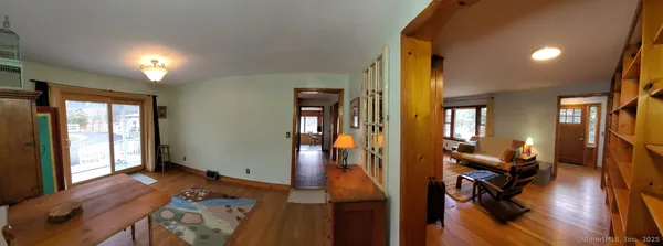 a view of an entryway with furniture and floor to ceiling window