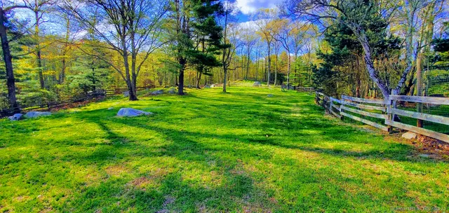 a view of a house with a tree in a yard