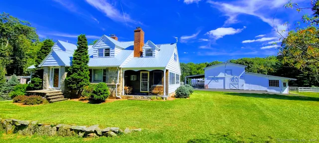 a view of a house with a yard porch and sitting area