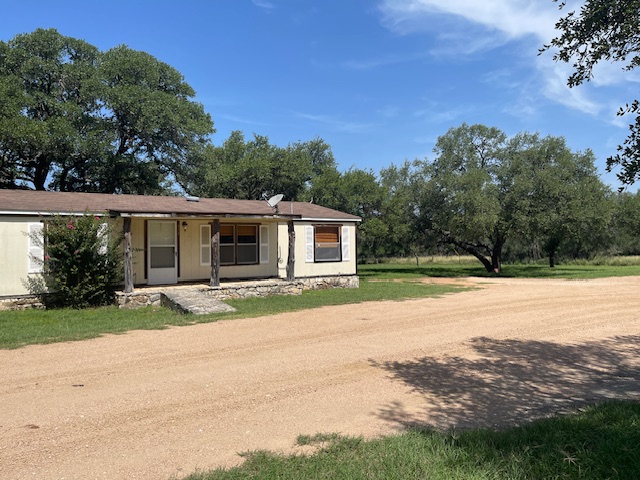 front view of a house with a yard and a street