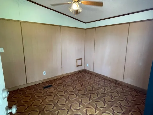 a view of a room with an empty space and a ceiling fan