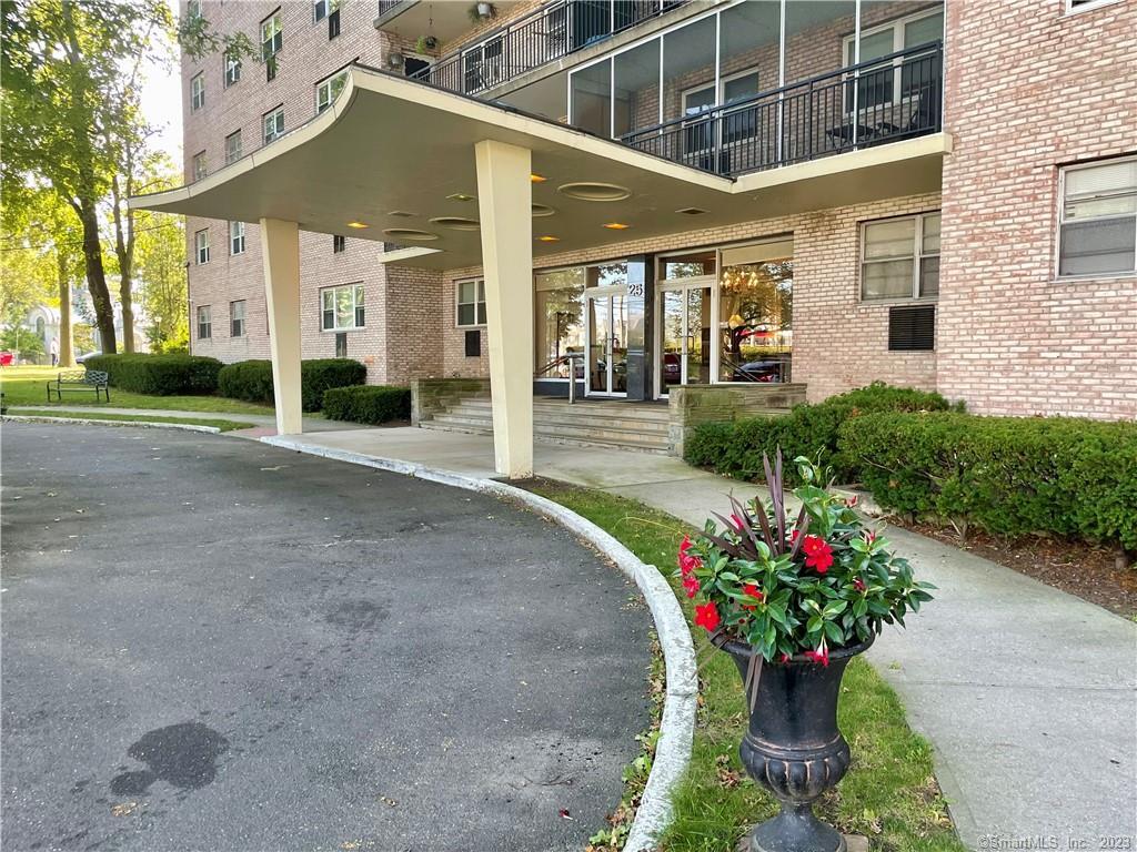 25 Cartright Street, Unit 7K Bridgeport, CT 06604 - Photo 1 of 1 a house with flowers in front of it