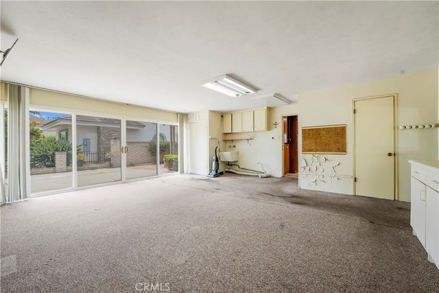 a view of empty room with wooden floor and windows
