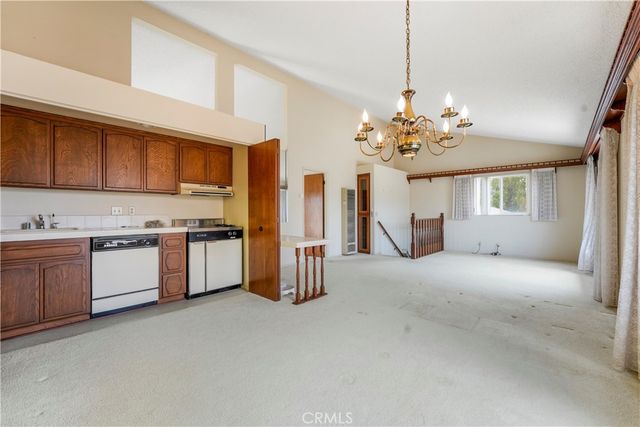 a view of empty room with wooden floor and ceiling fan