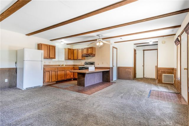 an aerial view of a house with a garden and lake view