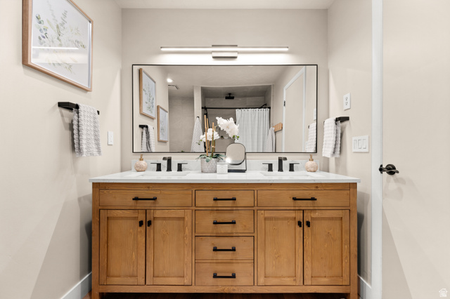 2163 Borg Drive Sandy, UT 84092 - Photo 20 of 31 Bathroom featuring double vanity and a shower with shower curtain