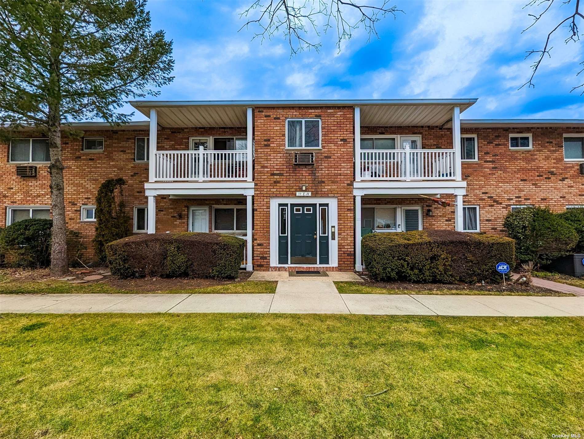 59 Adams Road, Unit 2F Central Islip, NY 11722 - Photo 1 of 1 a front view of a house with a yard